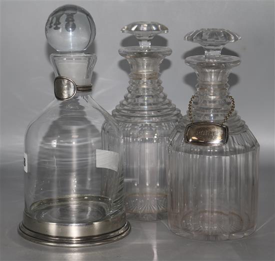 A pair of Victorian cut glass decanters and another